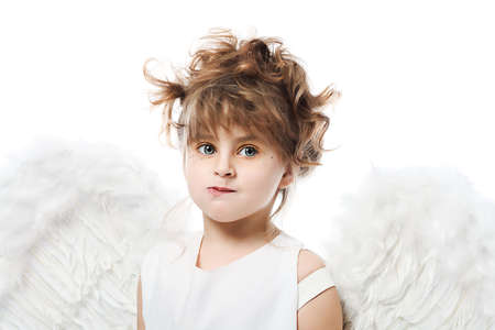 Beautiful little angel isolated over white background.の写真素材