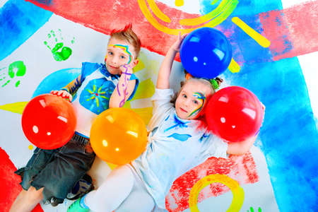Two beautiful children enjoying their painting. Education.の写真素材
