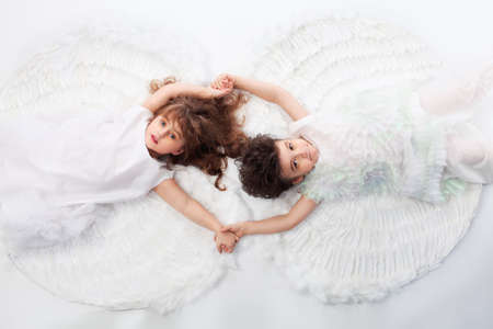 Beautiful little angels. Isolated over white background.の写真素材