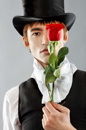 Portrait of a young gentlemen wearing dinner jacket and black top hat. Shot in a studio.の写真素材