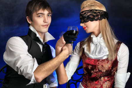 Portrait of the elegant young couple in 18, 19th century costumes. Shot in a studio.