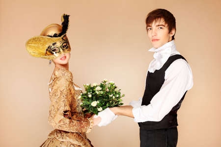 Portrait of a beautiful couple in medieval era costumes. Shot in a studio.