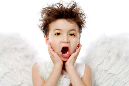 Emotional little angel isolated over white background.の写真素材