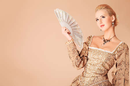 Portrait of a beautiful woman in medieval era dress. Shot in a studio.