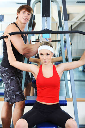 Couple of a sporty young people in the gym centre.