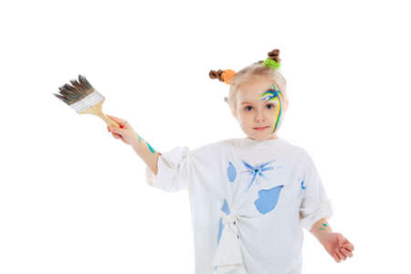 Portrait of a beautiful child enjoying her painting. Education.の写真素材