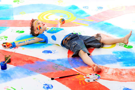 Portrait of a beautiful child enjoying his painting. Education.の写真素材