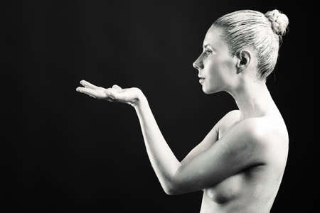 Portrait of an artistic woman painted in metal style. Shot in a studio.の写真素材