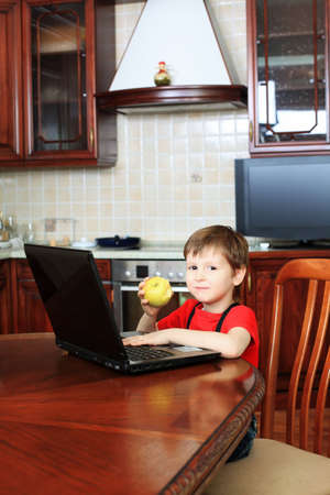 Little boy with his laptop at home.の写真素材