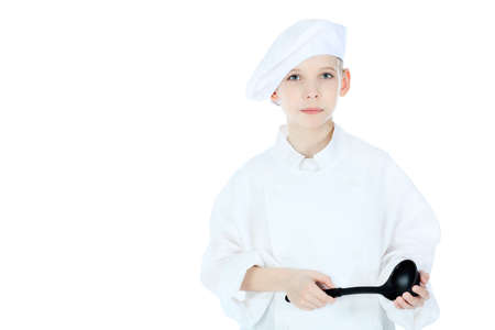 Shot of a little kitchen boy in a white uniform. Isolated over white background.の写真素材