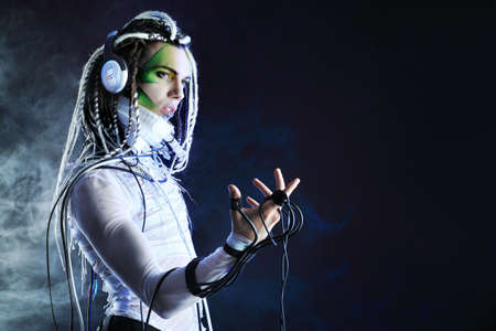 Shot of a futuristic young man in headphones and with wires.の写真素材