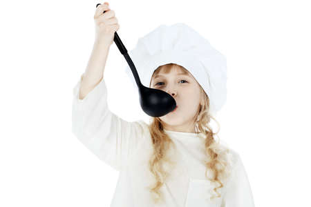 Shot of a little kitchen girl in a white uniform. Isolated over white background.の写真素材