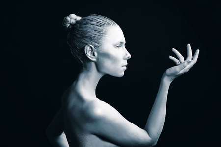 Portrait of an artistic woman painted in metal style. Shot in a studio.の写真素材