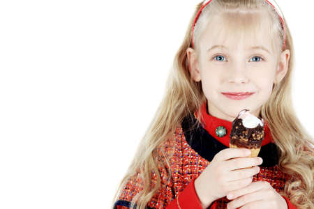 Little girl is eating chocolate ice-cream. Isolated over white background.の写真素材