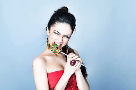 Portrait of a beautiful girl with big lollipop.の写真素材