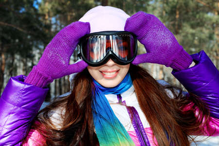 Pretty young woman having a rest outdoor in winter.の写真素材
