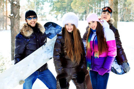 Group of young people having a rest outdoor in winter.の写真素材