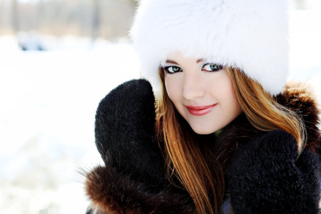 Pretty young woman in a winter park.