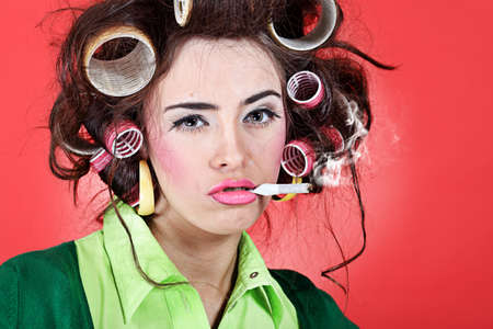 Shot of a funny  woman housewife dressed in retro style. の写真素材