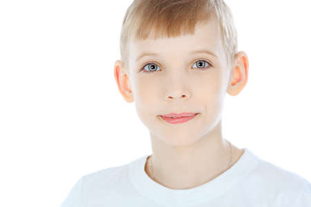 Portrait of a cute boy isolated over white background.の写真素材