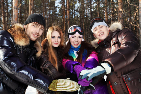 Group of young people having a rest outdoor in winter.