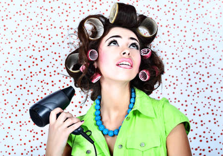 Shot of a funny  woman housewife dressed in retro style. の写真素材