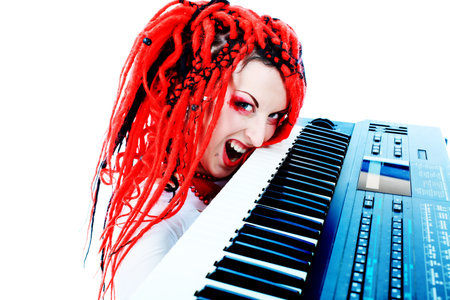 Rock musician is playing synthesizer. Shot in a studio.