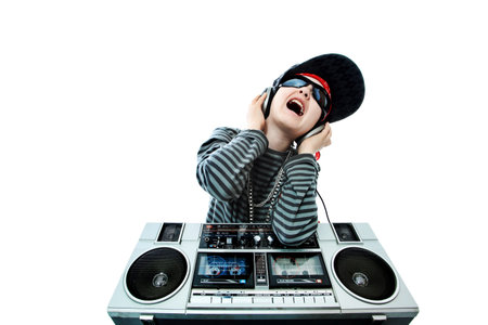 Shot of a trendy teenager listening to music in headphones. Isolated over white background.