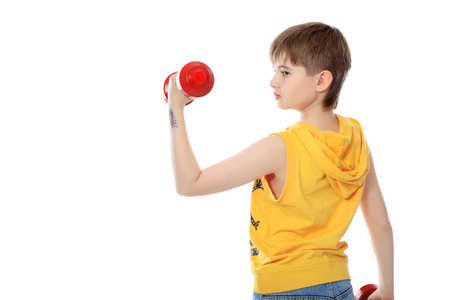 Shot of a sporty boy teenager with dumbbells. Isolated over white background.の写真素材