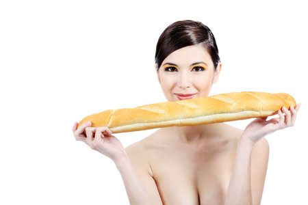 Portrait of a beautiful young woman holding baguette.の写真素材