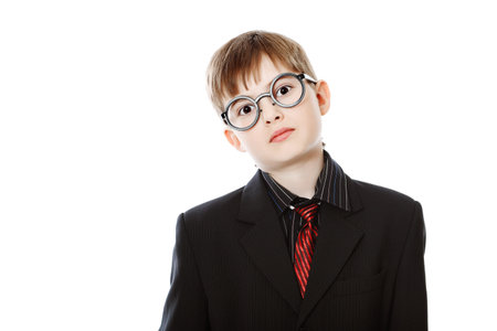 Educational theme: boy teenager posing in a suit and spectacles. Isolated over white background.