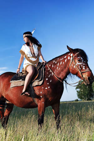 Beautiful young woman posing with a brown horse.の写真素材