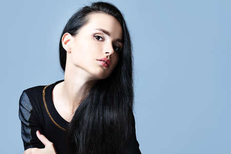 Fashion photo, a model is  posing over grey backgroundの写真素材