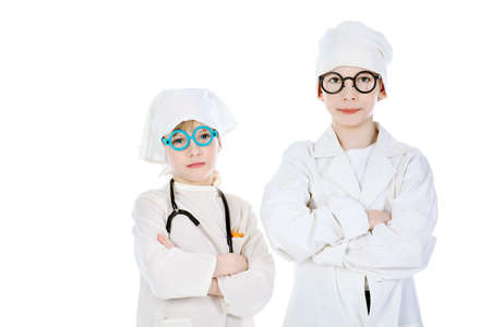 Shot of a little girl and boy in a doctors uniform. Isolated over white background.の写真素材