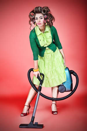 Shot of a funny  woman housewife dressed in retro style. の写真素材