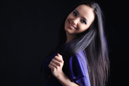 Fashion model is  posing over black backgroundの写真素材