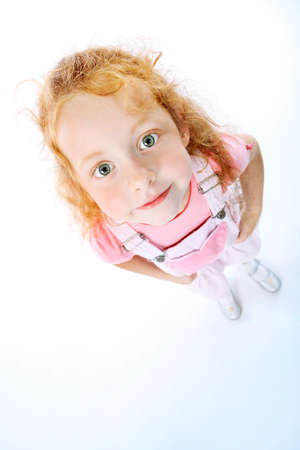 Portrait of a cute red-haired girl. Isolated over white background.の写真素材
