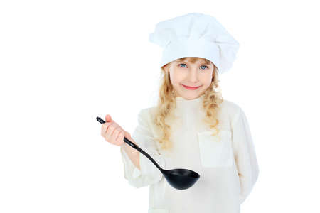 Shot of a little kitchen girl in a white uniform. Isolated over white background.の写真素材