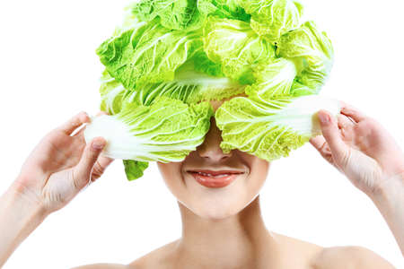 Shot of a beautiful young woman with vegetables headwear. Food concept, healthcare.の写真素材