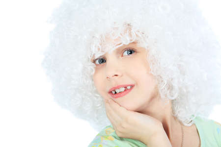 Portrait of a smiley 6 years old girl in white wig. Isolated over white background. の写真素材