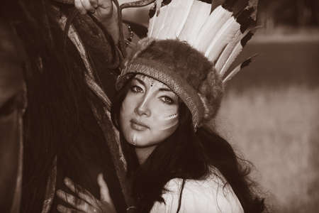 Beautiful young woman posing with a brown horse.の写真素材