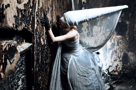 Shot of a twilight girl in white dress. Halloween, horror.の写真素材