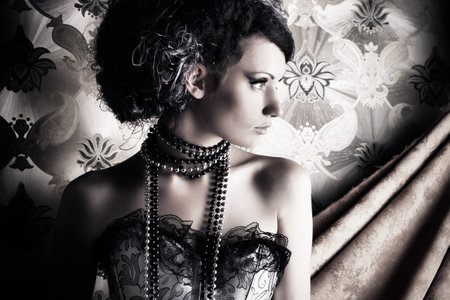 Beautiful fashionable woman over vintage background.