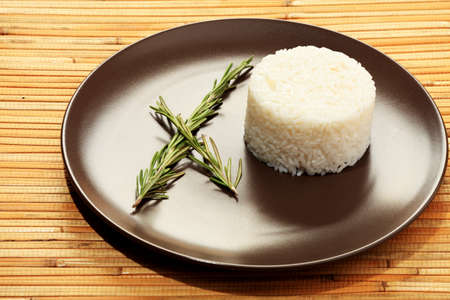 Steamed white rice on a  brown plate.の写真素材