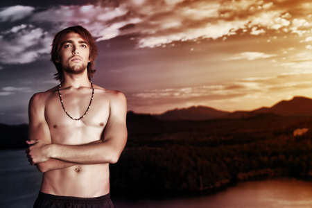 Shot of a sexual young man posing topless outdoors.の写真素材