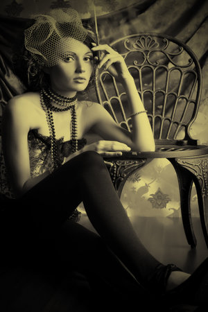 Beautiful fashionable woman over vintage background.