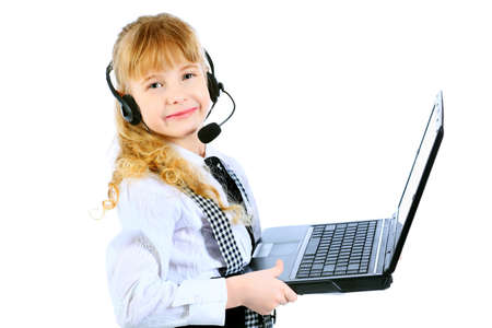 Shot of a little girl in headphones with microphone sitting with her laptop. Isolated over white background.の写真素材