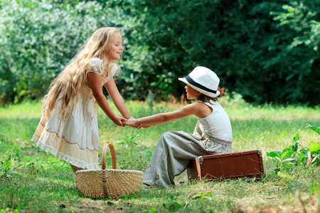 Two beautiful children walking together. Retro style.の写真素材