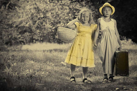 Two beautiful children walking together. Retro style.の写真素材