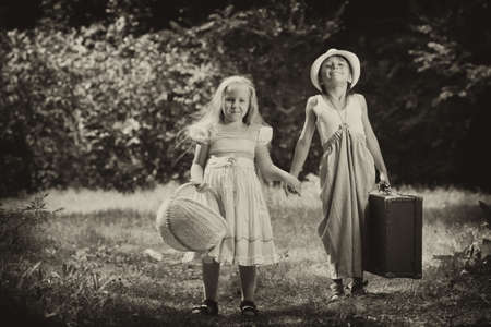Two beautiful children walking together. Retro style.の写真素材